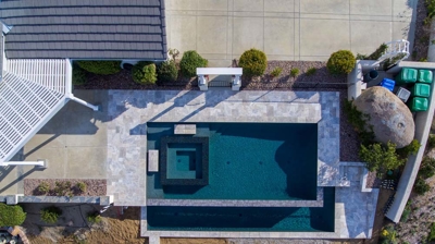 Pool with spa and patio from above Photo