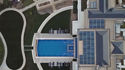 Pool with spa and custom patio from above Photo