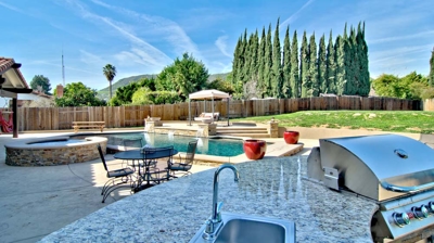 Outdoor kitchen island with sink and grill Photo