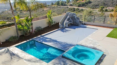 Closing pool cover with spa and slide Photo