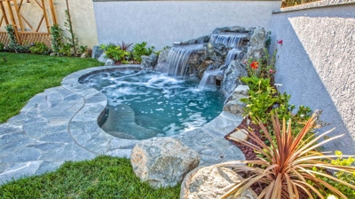Small backyard pool with waterfall Photo