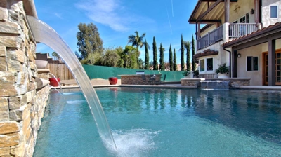 Custom stone waterfall into pool Photo