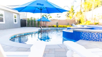 Poolside perfection: White Adirondack chairs adorn the backyard oasis. Photo