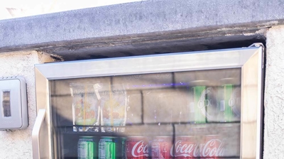 Lounge in comfort on the patio furnished with a BBQ area and a fridge for drinks. Photo