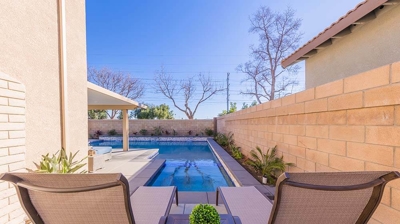 Lounge in chairs on the side yard facing the pool. Photo