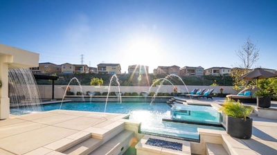 Pool with deck jets and patio area Photo