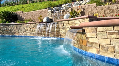 A backyard oasis with cascading waterfalls and a serene swimming pool. Photo