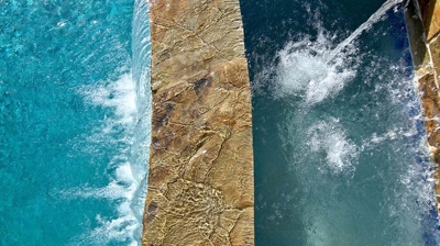 Backyard pool with a cascading waterfall feature. Photo