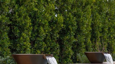 Large water features with water cascading into a swimming pool. Photo