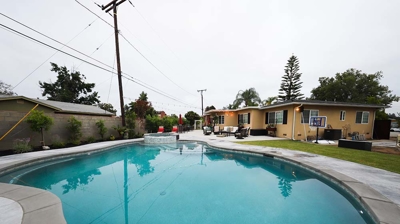 Ground-level backyard pool with a raised spa for elevated relaxation. Photo