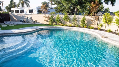 An in ground swimming pool with large steps inside. Photo