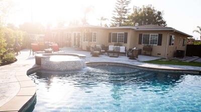 Ground-level backyard swimming pool accompanied by a raised spa for elevated comfort. Photo