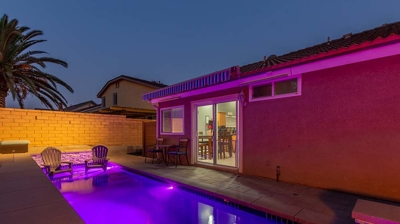 A lengthy rectangular pool equipped with a built-in spa, offering abundant seating options. Photo
