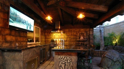 Otherworldly outdoor kitchen and bar enclave with a mystical island vibe. Photo