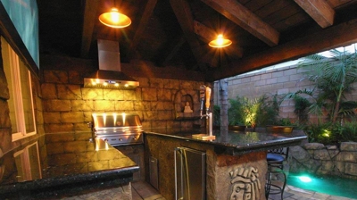 Fantasy island-inspired outdoor kitchen and bar haven. Photo