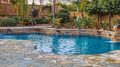 Outdoor pool with gorgeous stone flooring. Photo