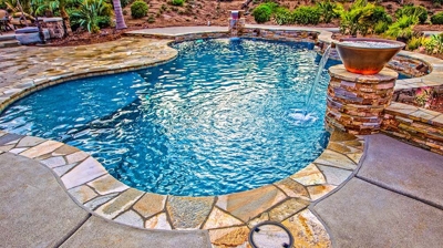 Outdoor pool with stone flooring. Photo