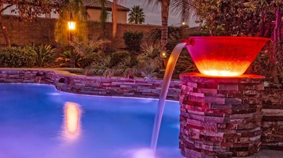 Pool with a view of bucket of water design of waterfall. Photo