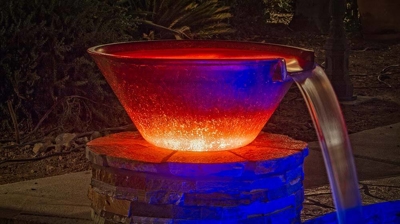 Pool with a view of bucket of water design of waterfall. Photo