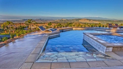 Beautiful view of pool with stone floor and scenery. Photo