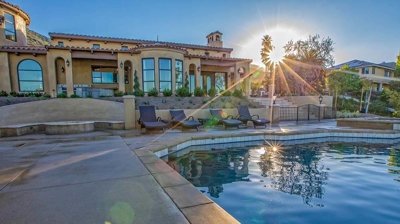 Beautiful view of pool and jacuzzi with stone floor and scenery. Photo