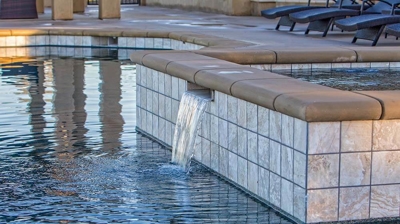 Small waterfall flowing into pool. Photo