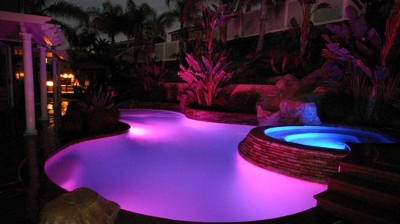 Pink lit pool and blue lit jacuzzi with gorgeous night time views. Photo
