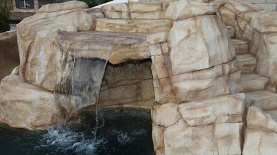 Serene waterfall built within pool. Photo