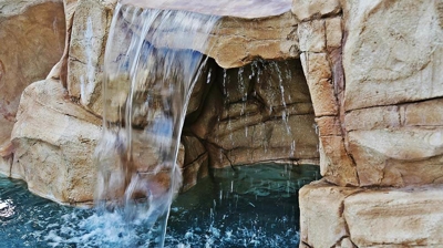 Serene waterfall built within pool. Photo