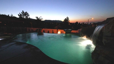 Lit up pool in the night time sky. Photo