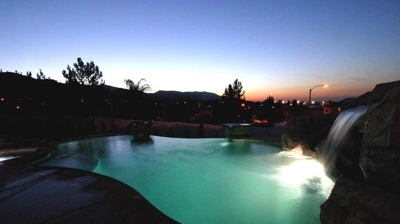 Lit up pool in the night time sky. Photo