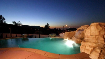 Lit up pool in the night time sky. Photo