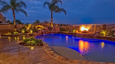 Luxurious tropical island getaway with a pool, spa, and captivating fire accents. Photo