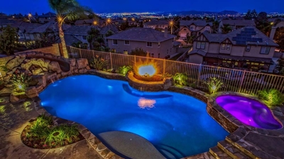 Exotic backyard oasis inspired by tropical islands, featuring pool, spa, and mesmerizing fire features. Photo