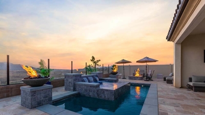 Captivating poolside escape: elevated spa, waterfall, fiery surroundings. Photo