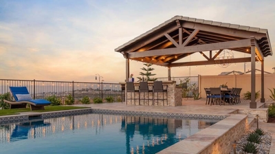 Backyard pool and spa oasis with lounge chairs and panoramic sunset vistas. Photo