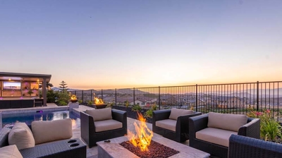 Lounge set with fireplace table surrounded with a beautiful and serene view. Photo