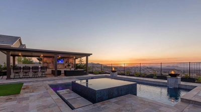 An outdoor pool with a sunset view offers a truly idyllic experience. Photo