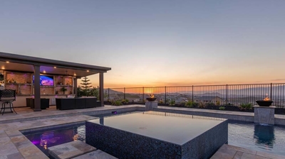 A backyard pool with a view offers a luxurious and serene setting for relaxation and entertainment. Photo