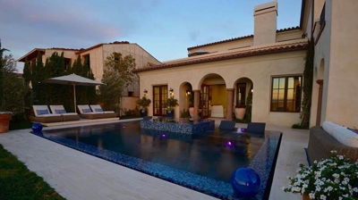 Sunset on pool and gorgeous backyard. Photo