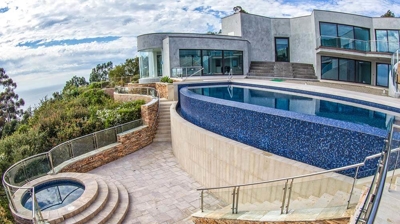 View of both jacuzzi and pool in gorgeous backyard with view. Photo