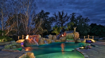Custom freeform pool illuminated at night Photo