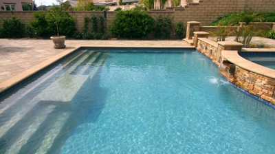 Pool with stairs and water features Photo