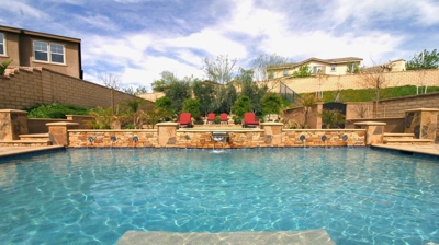 View over backyard pool with custom masonry work Photo