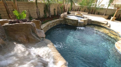 Small backyard pool with waterfall and custom spa Photo