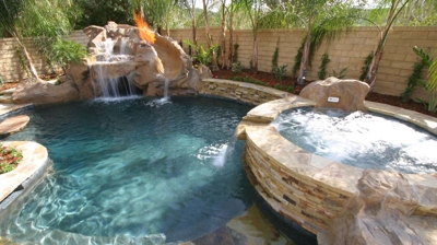 Small backyard pool with spa and waterfall feature Photo