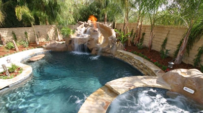 Small backyard pool with spa, waterfall, and landscaping Photo