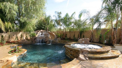 View of custom backyard patio with pool and spa Photo