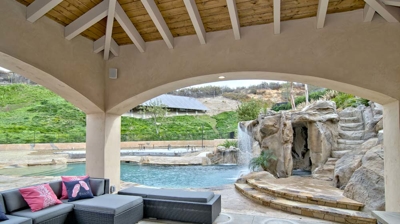 Outdoor sitting under a gazebo next to a pool Photo