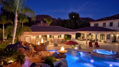 Pool with fire features at twilight Photo